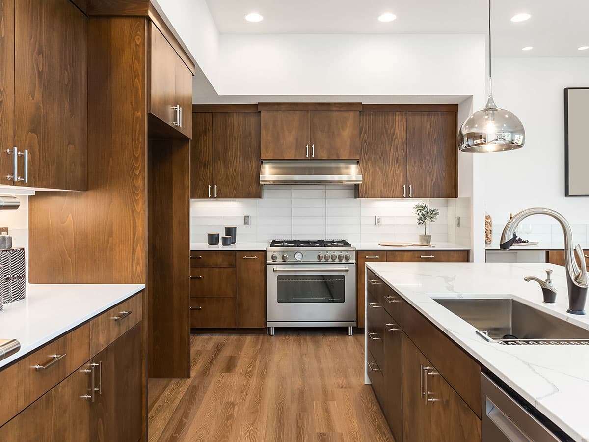 wide brown kitchen with marble countertop